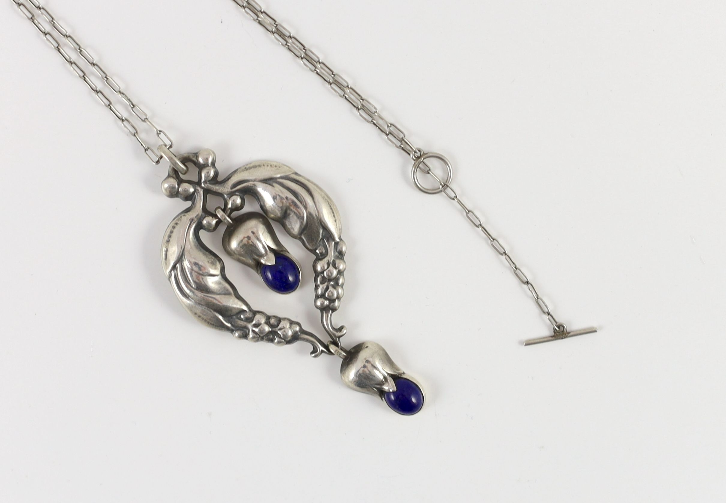 A 1920's George Jensen sterling silver and two stone lapis lazuli set drop pendant, design no. 51
